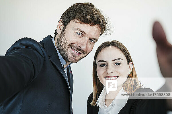 Happy businessman with businesswoman in coworking office