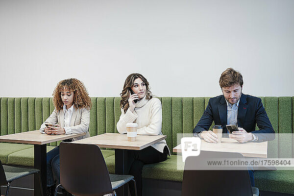 Businessman and businesswomen sitting in cafeteria