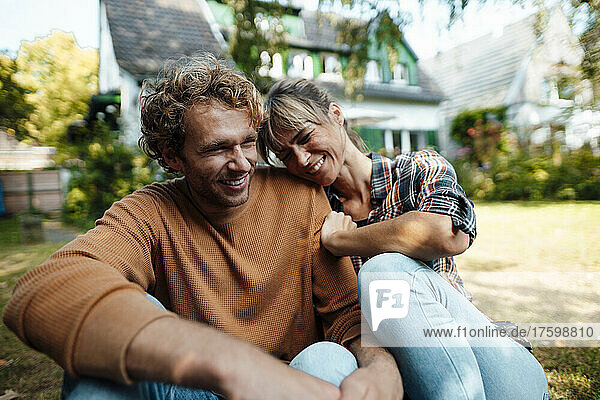 Couple laughing together in garden