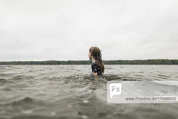 Girl with long brown hair in lake