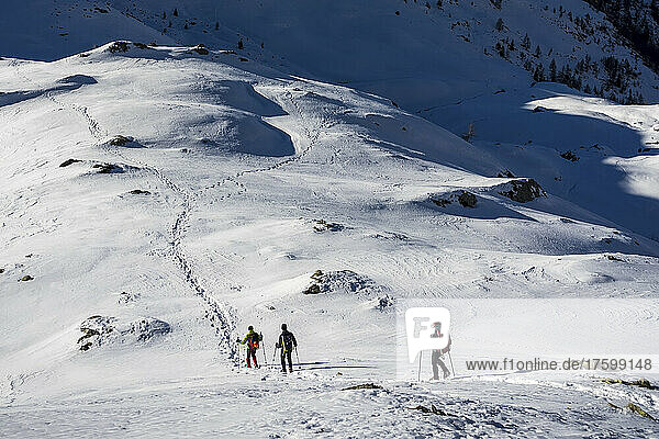 Ski mountaineerers moving down from snowy mountain at Orobic Alps in Valtellina  Italy