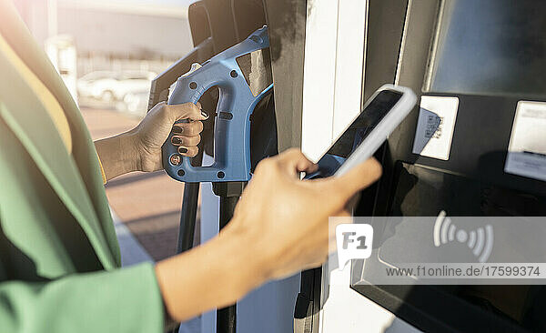 Commuter scanning QR code at gas station