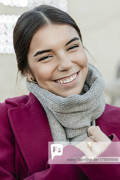 Smiling young beautiful woman wearing scarf