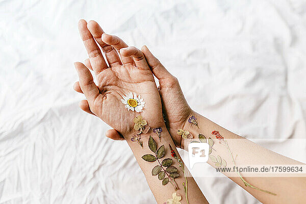 Flowers arranged on woman's hands