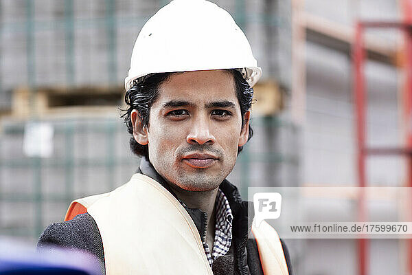 Portrait of confident engineer wearing hardhat