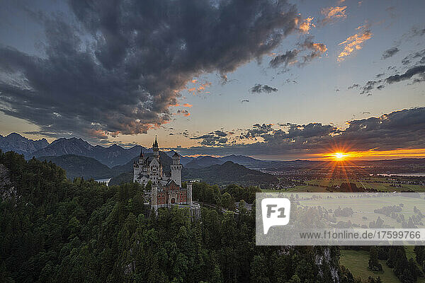 Germany  Bavaria  Schwangau  Clouds over Neuschwanstein Castle at sunset