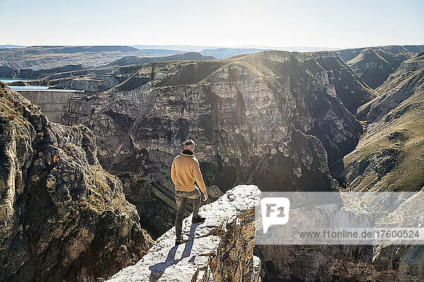 Man standing on mountain on sunny day