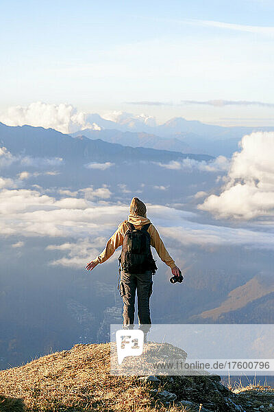 Carefree tourist standing at cliff on mountain at Caucasus Nature Reserve in Sochi  Russia