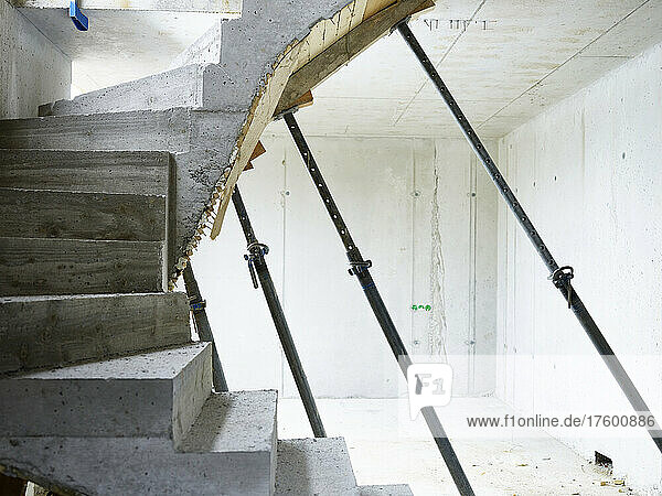 Concrete staircase supported by metal poles at construction site