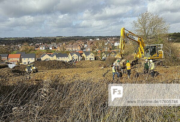 Workers and machinery doing groundwork new housing development  Calne  Wiltshire  England  UK