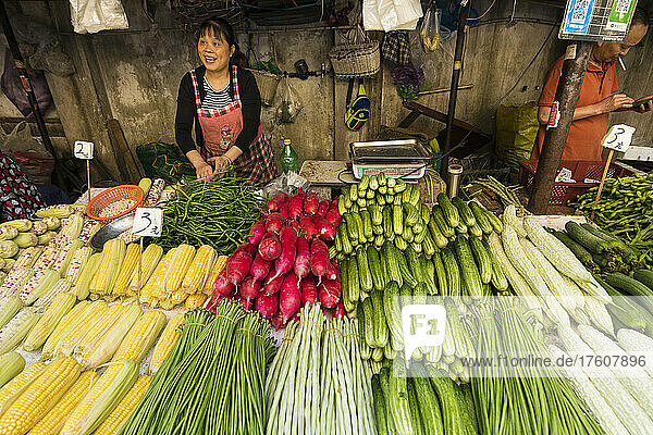 Woman selling a selection of vegetables for sale in market; Chengdu Shi  Sichuan Sheng  China
