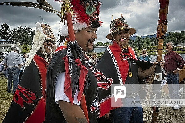 Dressed in colorful traditional clothing  Tlingit tribe leaders celebrate after a ceremony involving six totem poles that were raised in a Native Alaskan local park; klawock  Alaska  United States of America