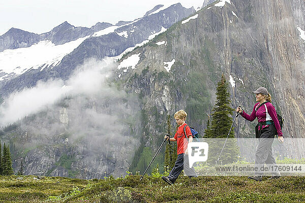 Mom and six year old son hiking high in the Adamants Range.; Rocky Mountains  British Columbia  Canada.