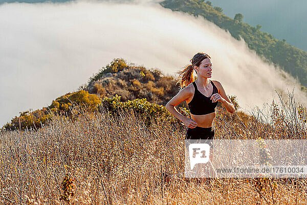 A woman running among clouds.