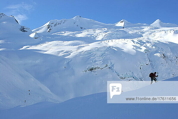A back country snowboarder and a glacier.; Selkirk Mountains  British Columbia  Canada.