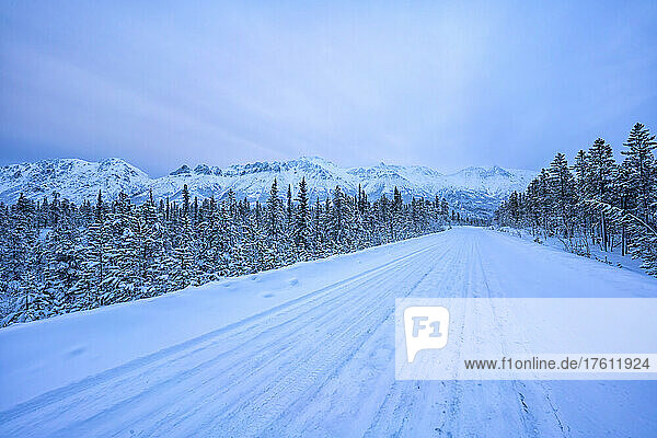 The snow-covered mountains of the Gray Ridge along the Annie Lake Road in early morning light in winter; Whitehorse  Yukon  Canada