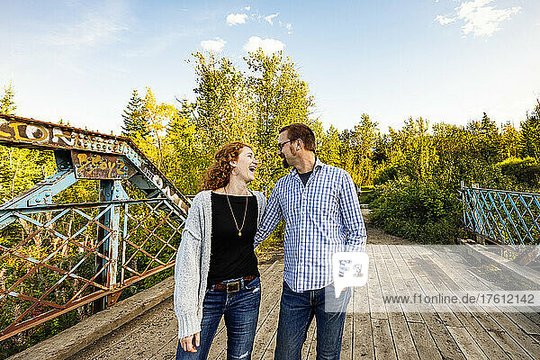 Mature married couple enjoying time together outdoors in a park in autumn; Edmonton  Alberta  Canada