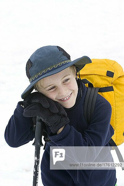 A young happy boy takes a break from hiking; Adamants Mountain Range  British Columbia  Canada