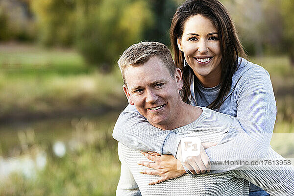 Portrait of a mid adult couple in a park in autumn; St. Albert  Alberta  Canada