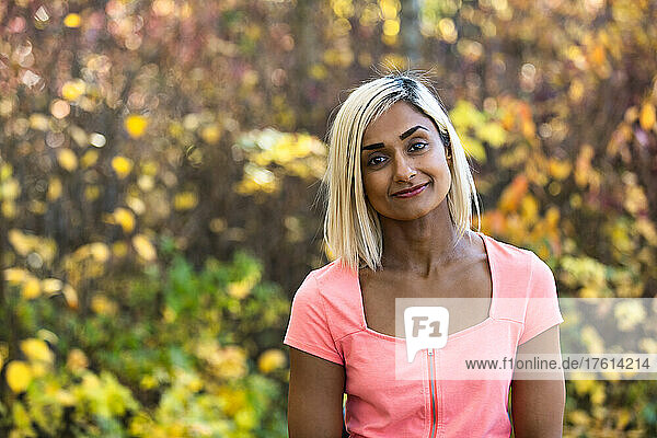 Head and shoulders portrait of a woman outdoors in autumn; Edmonton  Alberta  Canada