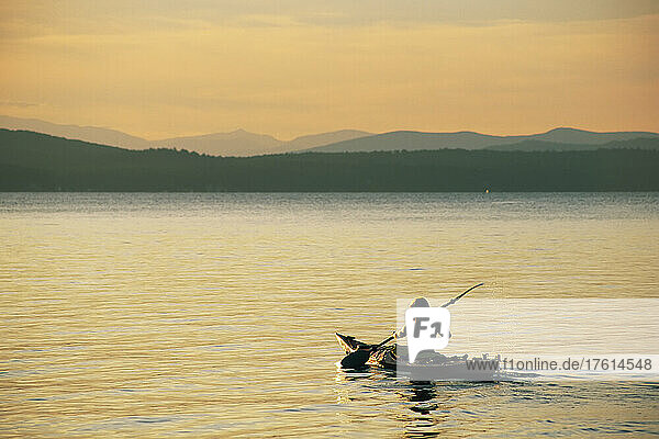 A woman kayaking on Sebago Lake.; Sebago Lake  Maine.