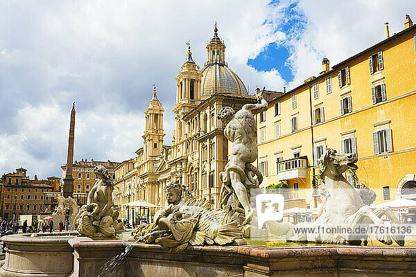 Fountain of Neptune and Church of St Agnese in Agonein in the background  Piazza Navona; Rome  Lazio  Italy