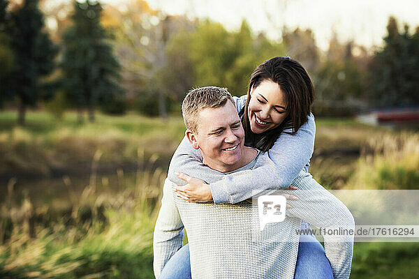Portrait of a mid adult couple in a park in autumn; St. Albert  Alberta  Canada