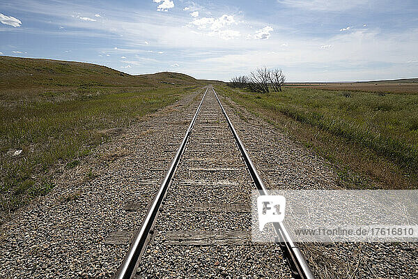 Railroad tracks on a vast landscape of the Canadian prairies leading into the distance; Sanctuary  Saskatchewan  Canada