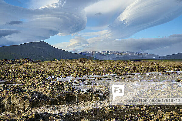 Gletscherfluss  der durch die Basaltlandschaft fließt  mit einem dramatisch bewölkten Himmel entlang des Kaldidalur-Tals; Husafell  Nordurland Vestra  Island