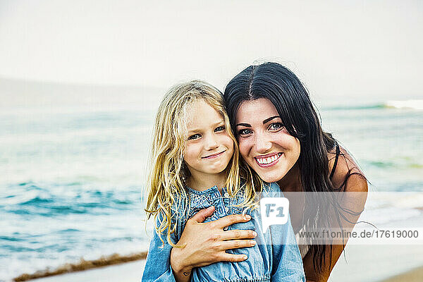 Portrait of a mother and daughter on Ka'anapali Beach at the water's edge; Ka'anapali  Maui  Hawaii  United States of America