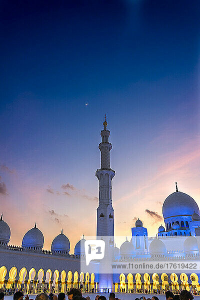 Sunset with a quarter moon at the Grand Mosque in Abu Dhabi  UAE  featuring a marble minaret; Abu Dhabi  United Arab Emirates