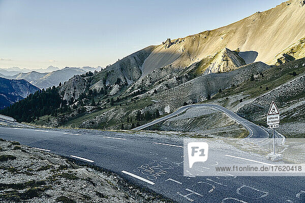 Sign board on road by mountains at sunset  Col d'Izoard  Arvieux  France