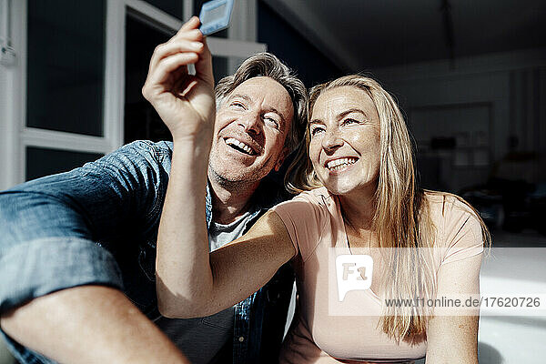 Smiling couple looking at photographic slide