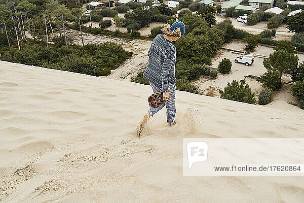 Woman running on Dune of Pilat at vacation