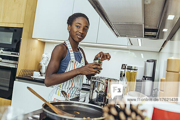 Pre-adolescent girl preparing food in kitchen at home