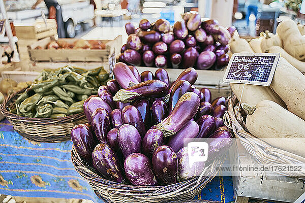 Fresh eggplants in basket at market