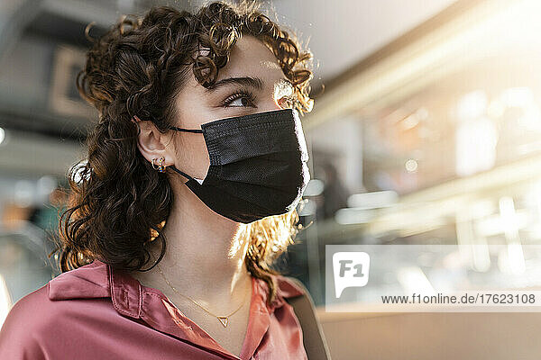 Young woman wearing protective face mask