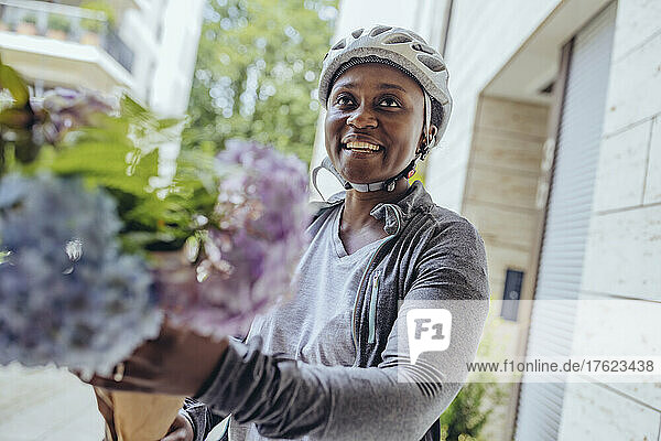Happy delivery woman with flower bouquet