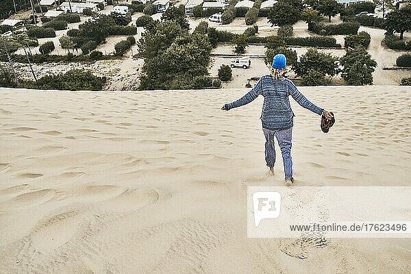 Tourist running on Dune of Pilat at vacation