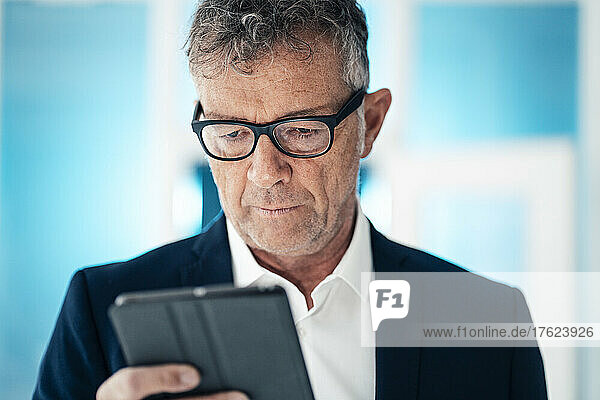 Businessman with eyeglasses using tablet computer