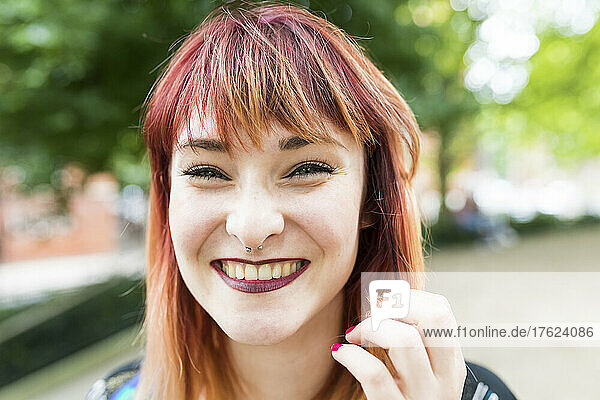 Cheerful redheaded woman with nose ring