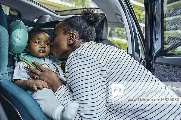 Mother kissing her son in car