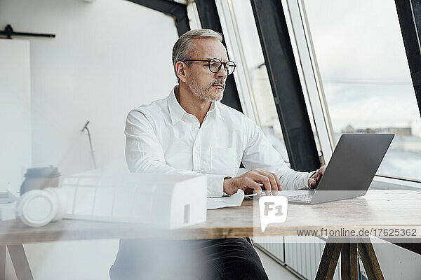 Architect using laptop at work place
