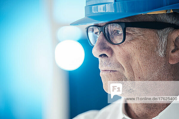Thoughtful construction worker with eyeglasses