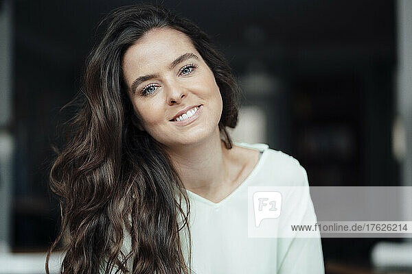 Smiling brunette woman in cafe