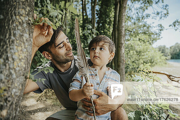 Father and son looking at tree on weekend