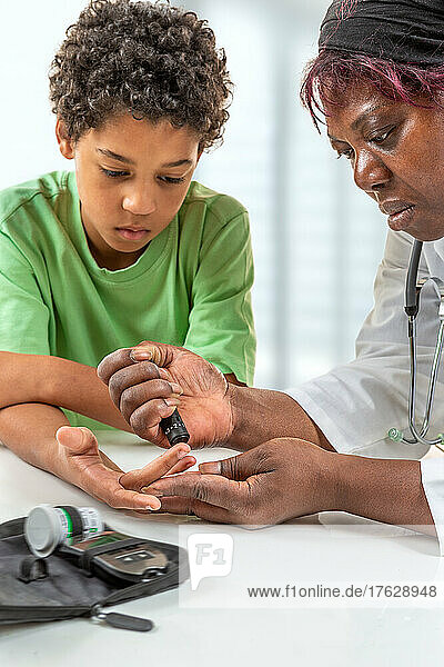 Concept children diabetes children with glucometer learning to check blood sugar level at home. Learn to use a glucometer. Education of diabetic kids  at hospital