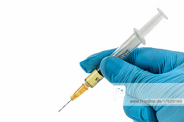 Gloved hands holding a syringe dose. Concepts of medical treatment  epidemic or vaccine