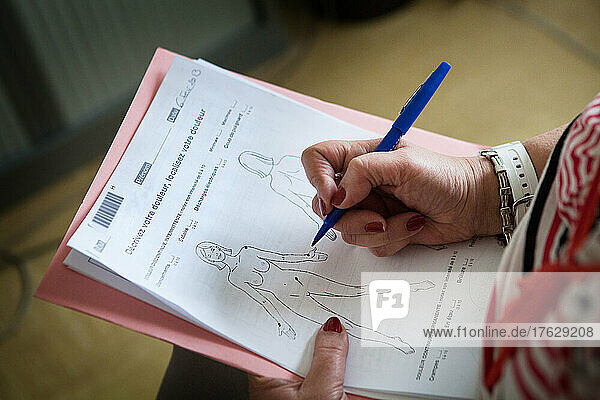 A patient fills out a form to assess and target chronic pain.