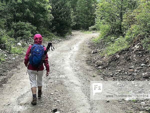 Senior female hiker in a mountain path.